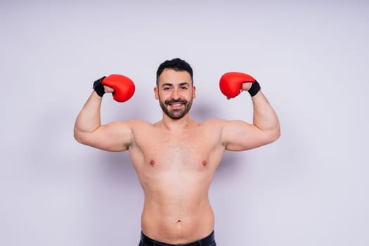 Young caucasian handsome man isolated on a white background with boxing gloves