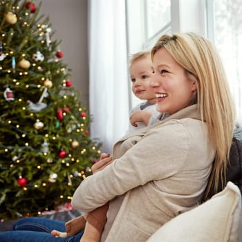 Motherhood is a happy place. a young mother enjoying Christmas with her little boy