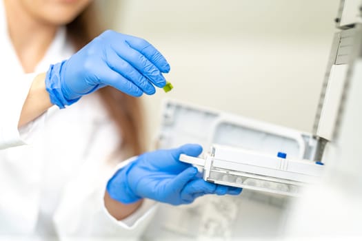 chemical sample in the hand of a scientist in a research laboratory.