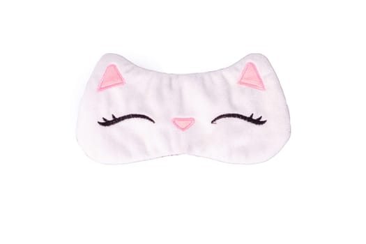White sleep mask in the form of a cat's muzzle, isolated, on a white background. Close up