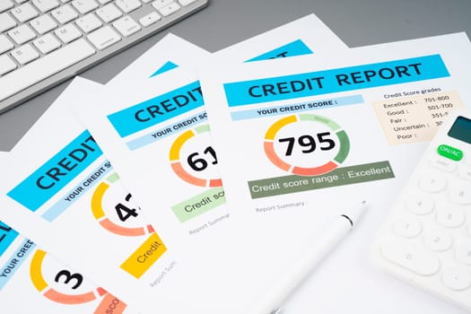 Credit score report document and pen with calculator on the desk.