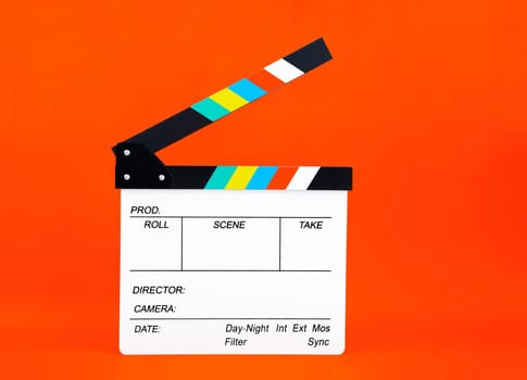 Movie clapper on orange background ; film, cinema and video photography concept