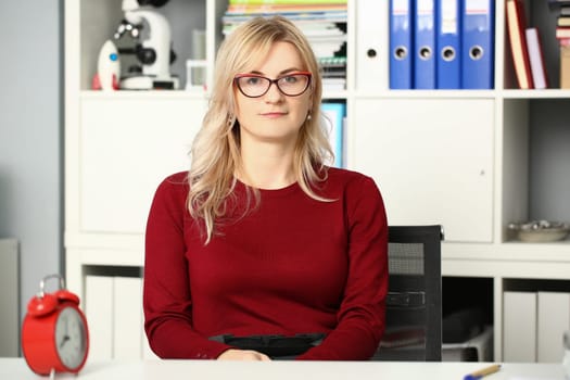 Portrait of businesswoman in glasses at workplace in office. Business consultant secretary or manager
