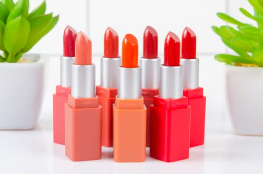 Various shade of matte lipsticks on white table.