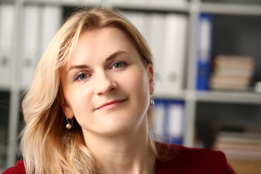Portrait of a beautiful smiling blonde businesswoman at workplace. Business consultant manager or leader concept