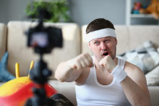 Confident man looking at the camera and clenching fist encouraging you to play sports. Remote fitness motivation and humor. Yes you can do it and believe in yourself