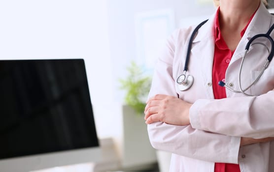 Female doctor standing with arms crossed on chest. Medical care or insurance and doctor appointment concept