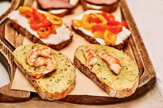 an item of food consisting of two pieces of bread with meat, cheese, or other filling between them, eaten as a light meal