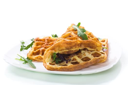 Egg omelet stuffed with onions and herbs, fried in the form of waffles, isolated on a white background
