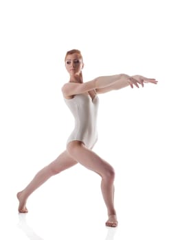Skinny redhead gymnast posing in leotard, isolated on white background