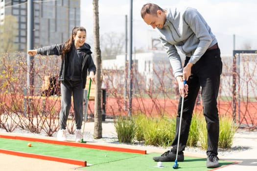 Family Time Playing Mini-Golf In The Summer.