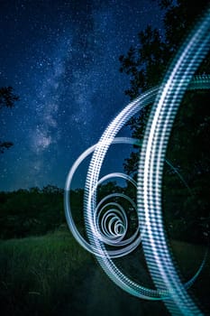 Illuminated arcs made of light at starry night