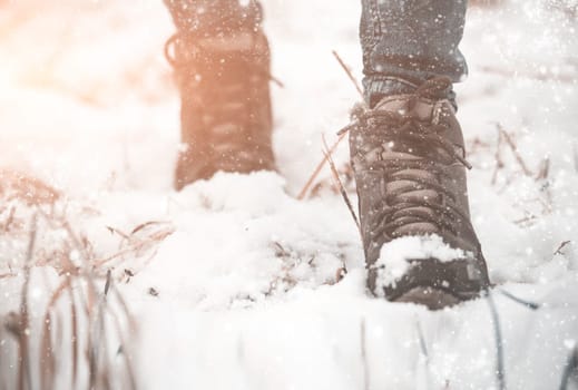 girl in winter boots walking on snowy road