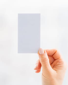 Hand holding empty white business card