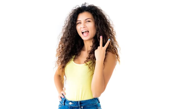 Attractive young girl showing victory gesture