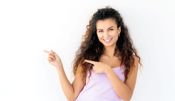 Cheerful smiling young girl pointing