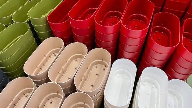 Close-up of empty flower pots in a store or greenhouse. Colorful pots for plants. Gardening and landscape design concept.