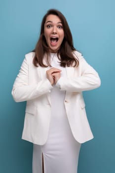 shocked dark-haired lady in white dress and jacket.