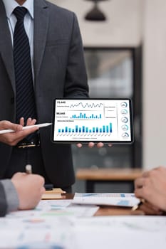 Close up of Diverse colleagues gather brainstorm discuss financial statistics at office meeting. finance, teamwork, Big data Graphs Charts concept.