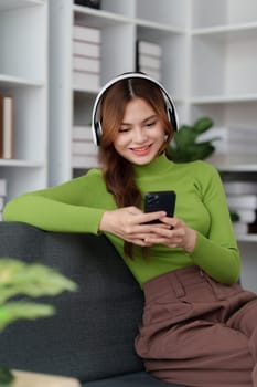 Attractive Asian woman resting comfortable living room and using mobile phone, Relax, Sofa, Lifestyle.