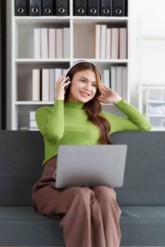 Attractive Asian woman resting comfortable living room and using laptop computer, Relax, Sofa, Lifestyle.