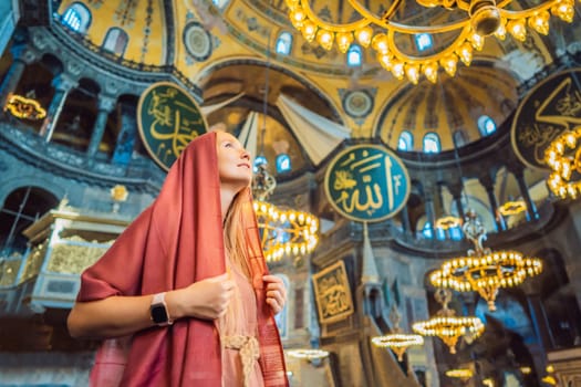 Woman tourist enjoying Hagia Sofia, Ayasofya interior in Istanbul, Turkey, Byzantine architecture, city landmark and architectural world wonder. Turkiye.