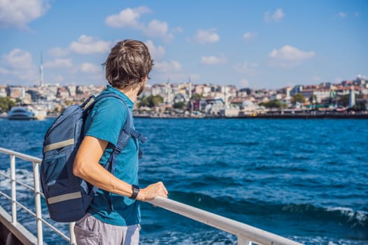 Happy man enjoying the sea from ferry boat crossing Bosphorus in Istanbul. Summer trip to Istanbul.