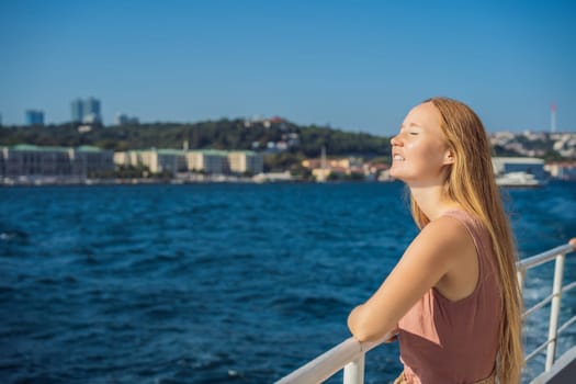 Happy woman enjoying the sea from ferry boat crossing Bosphorus in Istanbul. Summer trip to Istanbul.