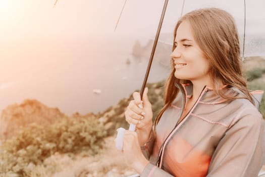 Woman rain park. Happy woman portrait wearing a raincoat with transparent umbrella outdoors on rainy day in park near sea. Girl on the nature on rainy overcast day