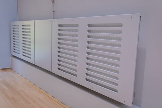 Installed typical system covers provided for sports hall radiators.