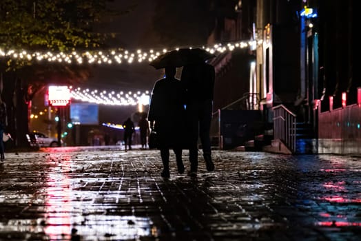 Together Under Umbrella. two people under an umbrella a man and a woman are walking in a city with an umbrella, walking in the rain, an autumn umbrella. Grayscale Photo of 2 Person Walking on Street. download image