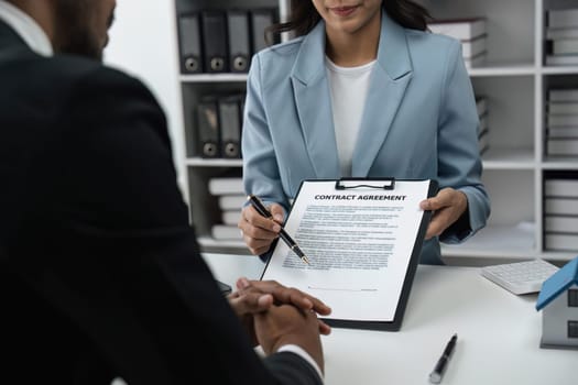 Real estate agent talked about the of the home purchase agreement and asked the customer to sign the documents to make the contract legally, Home sales and home insurance concept.