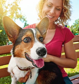 Quality time with her favorite furry friend. a young woman bonding with her dog in the park