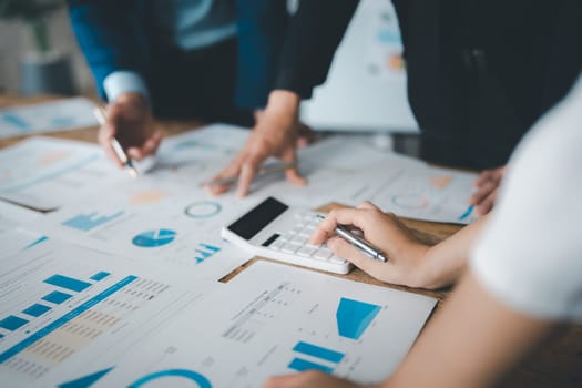 Accountant checking financial statement or counting by calculator income for tax form, Business woman sitting and working with colleague discussing the desk in office. Audit concept.