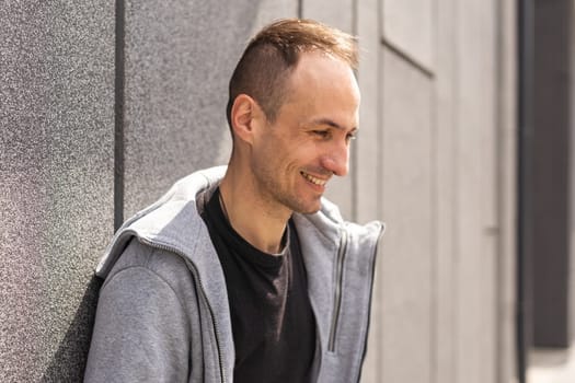 shot of young handsome male wears casual grey sweater.