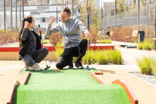 Mini-golf ball on artificial grass. Summer season game.