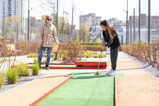 Family Time Playing Mini-Golf In The Summer.