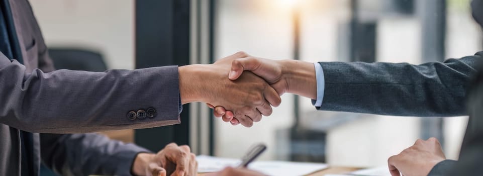 Business handshake for teamwork of business merger and acquisition,successful negotiate,hand shake,two businessman shake hand with partner to celebration partnership and business deal concept...