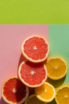 Creative background made of summer tropical fruits with leaves, grapefruit, orange, tangerine