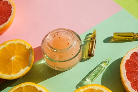 Cosmetic bottle containers with fresh orange slices, Blank label for branding mock-up, Natural beauty product concept.