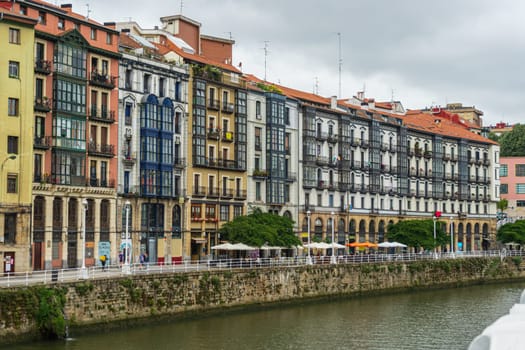 Bilbao, Spain - 08.06.2022: Bright multi colored houses of the Nervion River. Colorful architecture, Bilbao, Spain