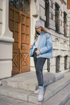 Portrait of a stylish woman in blue jacket. Spring outdoor portrait.
