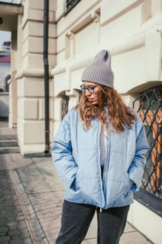 Portrait of a stylish woman in blue jacket. Spring outdoor portrait.