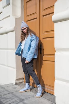 Portrait of a stylish woman in blue jacket. Spring outdoor portrait.