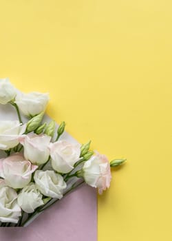 Composition with envelope and beautiful spring flowers on white background