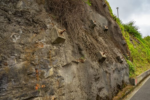 Rock bolts and Anchors to protect rock slopes from destruction. Protection of the rocky slope from collapse with reinforced concrete anchors