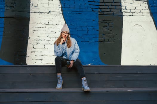 Portrait of a stylish woman in blue jacket. Spring outdoor portrait.