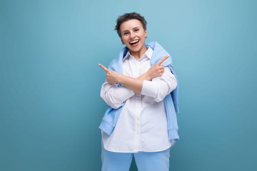 authentic young trendy dark haired woman in a cool look with crossed arms.