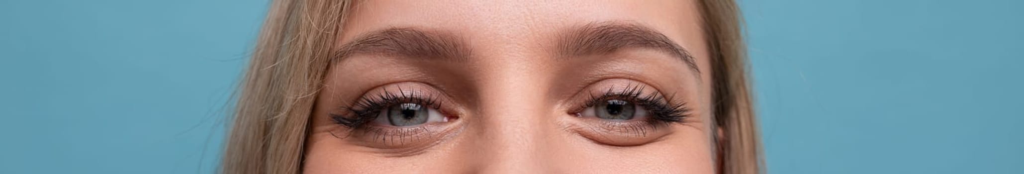 horizontal wide closeup photo of stunning female eyes in love.