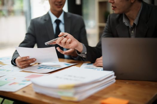 Asian business advisor meeting to analyze and discuss the situation on the financial report in the meeting room.Investment Consultant, Financial , teamwork ,brainstorming ,startup and accounting.